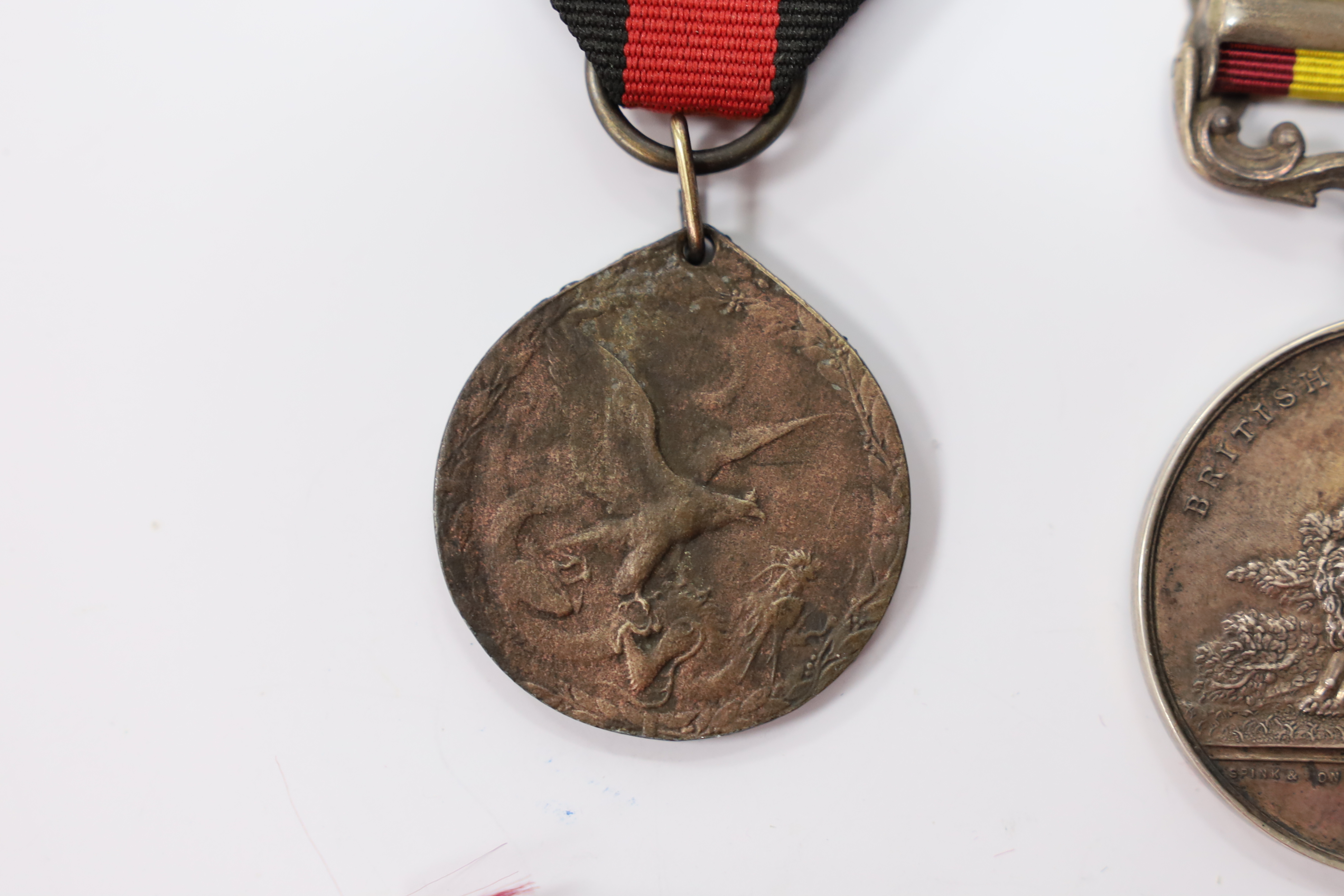 Assorted medals; two replica British North Borneo medals; Balaklava medallion; bronze GV medal; German China Campaign medal; bronze NRA medallion, unnamed